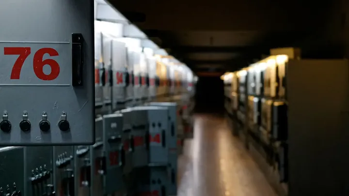 A corridor of numbered electrical panels