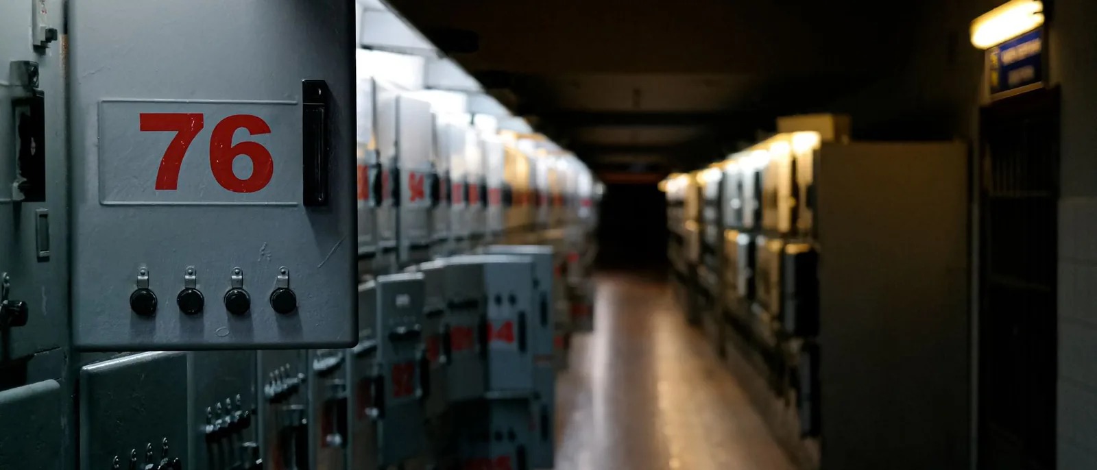 A corridor of numbered electrical panels