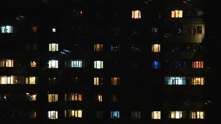 A building at night with most of its windows lit