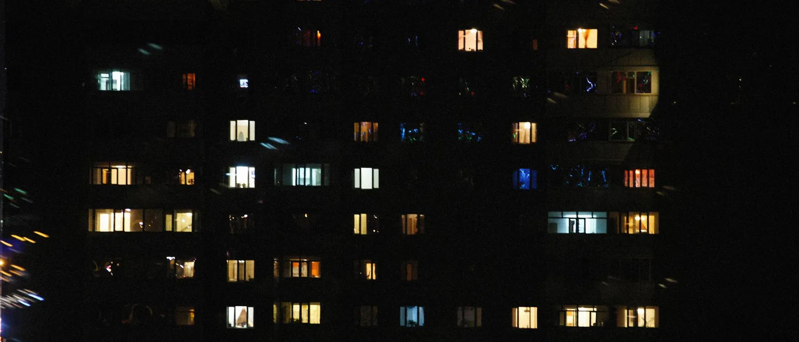 A building at night with most of its windows lit