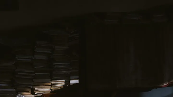 Identical crates stacked in a dark warehouse