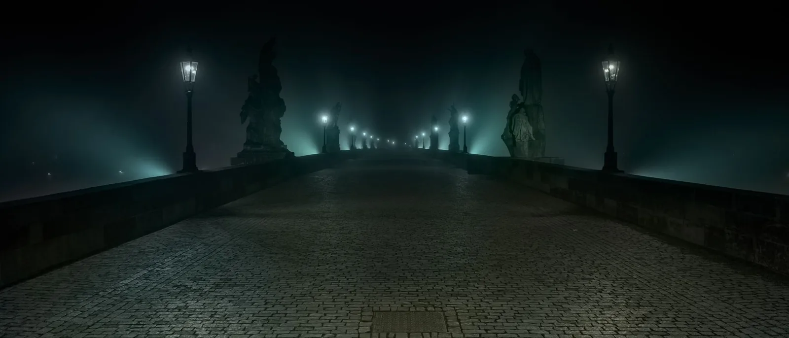 An old stone bridge at night in fog