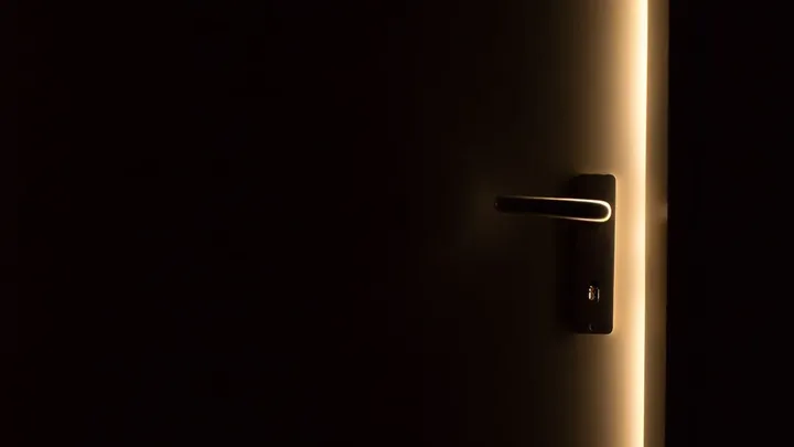 A phone screen lit in a dark room